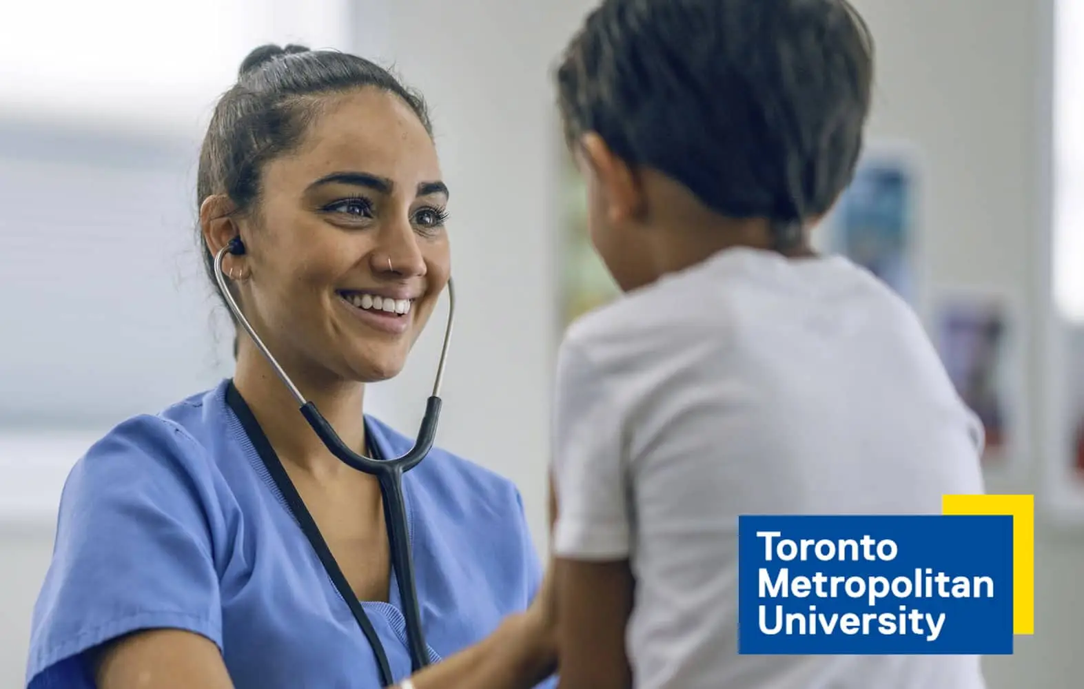 Smiling nurse treats child at toronto metropolitan university